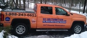 Water Damage and Mold Removal Truck On Residential Driveway