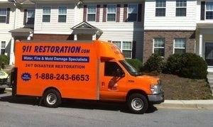 Water Damage Restoration Truck At Townhouse